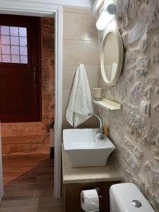a bathroom with a white sink and a mirror at Medieval Country House in Mastichochoria in Kalamoti