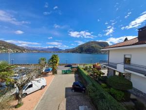 a house with a view of a body of water at VILLA AIDA LAKE VIEW in Lavena Ponte Tresa