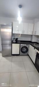 a kitchen with a stainless steel refrigerator and a dishwasher at Adan beach in Aourir