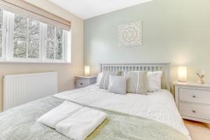 biała sypialnia z dużym białym łóżkiem z poduszkami w obiekcie Silver Stag Properties, 3 BR w Parking and Garden w mieście Smisby
