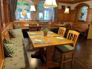 a dining room with a wooden table and chairs at Hotel Jungbräu in Abensberg