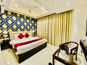 Schlafzimmer mit einem Kingsize-Bett und einem Tisch in der Unterkunft Blueberry Hotel zirakpur-A Family hotel with spacious and hygenic rooms in Chandīgarh