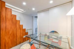 una mesa de cristal y una silla en una habitación en loft reformado en chueca para 4 personas en Madrid