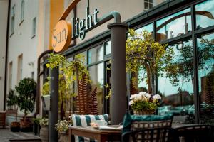 a cafe with a table and chairs in front of a store at Sunlight Hotel Conference & Spa in Nyköping