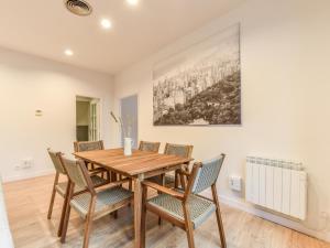 a dining room with a wooden table and chairs at apartamento en plaza de canalejas in Madrid