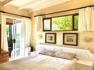 a bedroom with a large bed with a window at Bushmans River Lodge in Kenton on Sea