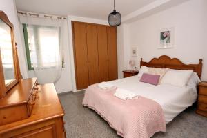 Posteľ alebo postele v izbe v ubytovaní Apartamento dos habitaciones primera línea de playa