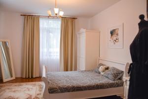 a bedroom with a bed with a teddy bear on it at Casa Humulesti, fii vecinul lui Ion Creanga in Tîrgu Neamţ