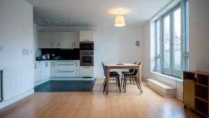 a kitchen with a table and chairs in a room at Central gorgeous flat with parking in Bristol