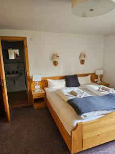 a bedroom with two beds and a bathroom at Die Schlickeralm in Telfes im Stubai
