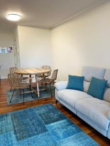 a living room with a couch and a table and chairs at Ocean SC Apartment in Santa Cruz