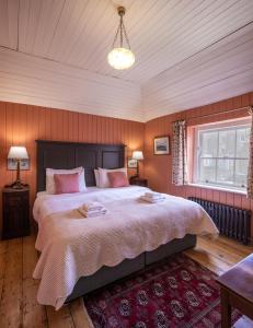 a bedroom with a large bed with pink pillows at Merrion Mews in Dublin