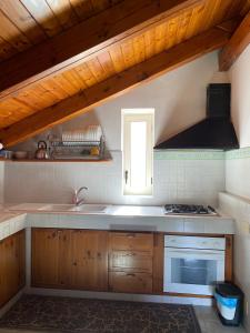 a kitchen with a sink and a stove top oven at Suggestivo appartamento vista mare in palazzo del'400 in Massa Lubrense