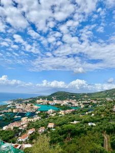 a view of a town with the ocean and buildings at Suggestivo appartamento vista mare in palazzo del'400 in Massa Lubrense