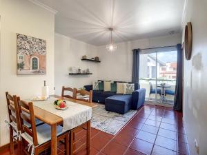 a living room with a table and a blue couch at Atlantic Breeze by Atlantic Holiday in Porto Moniz