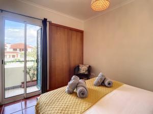 a bedroom with a bed with towels on it at Atlantic Breeze by Atlantic Holiday in Porto Moniz