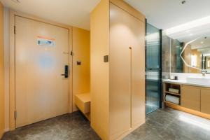 a bathroom with a shower and a sink at Derreal Hotel - Beijing Shunyi Guozhan Branch in Beijing