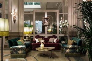 a living room with two couches and a table at Grand Hotel et de Milan - The Leading Hotels of the World in Milan