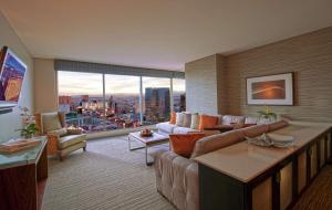 a living room with a couch and a large window at Hilton Grand Vacations Club Elara Center Strip Las Vegas in Las Vegas