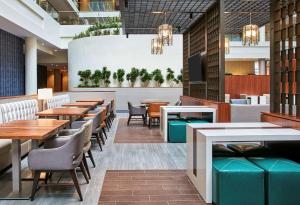 a restaurant with tables and chairs and a tv at Embassy Suites by Hilton Washington D.C. Georgetown in Washington