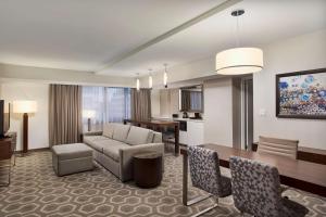 a living room with a couch and a table at Embassy Suites by Hilton Washington D.C. Georgetown in Washington