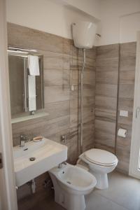 a bathroom with a white toilet and a sink at Villa Quantum in Siculiana Marina