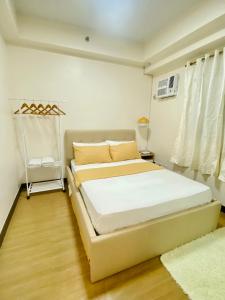 a bedroom with a large bed in a room at 17Eleven Staycation Home in Manila