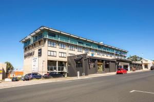 a building on a street with cars parked in front of it at Gateway Hotel by Nightcap Plus in Devonport