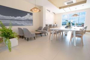 a dining room with a white table and chairs at Wyndham Garden El Morro Montecristi 