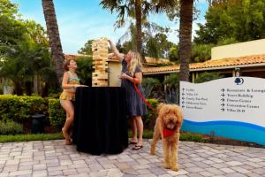 two women and a dog standing next to a table at DoubleTree by Hilton Hotel Orlando at SeaWorld in Orlando