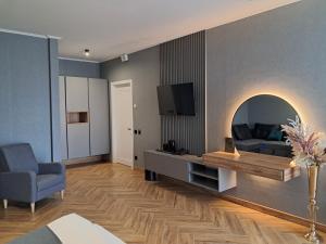 ein Wohnzimmer mit einem Sofa und einem TV in der Unterkunft Полінарія Козятин in Kozyatyn