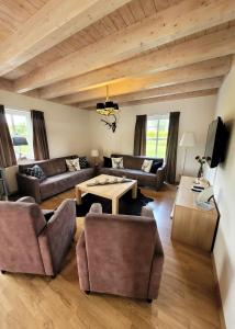 a living room with couches and a table at Winterberg Chalet 21096 in Winterberg