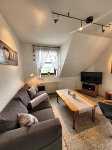 a living room with a couch and a coffee table at Winterberg Appartement 21103 in Winterberg