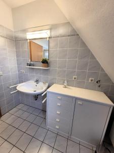 La salle de bains est pourvue d'un lavabo et d'un miroir. dans l'établissement Winterberg Appartement 21103, à Winterberg