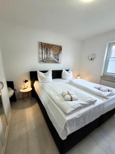 Postel nebo postele na pokoji v ubytování Winterberg Appartement 21108