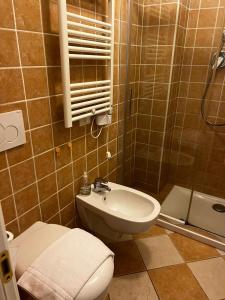 a bathroom with a toilet and a sink and a shower at Darsena Apartments in Savona