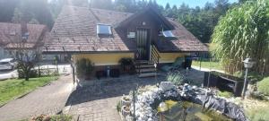 a house with a pond in front of it at Ferienhaus Erika in Voitsberg