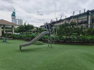 a slide in the middle of a field of grass at Prisma Residences - Celeste in Manila
