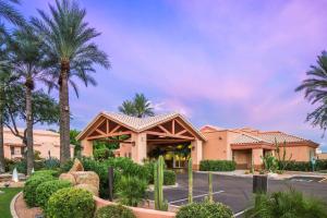 a resort with palm trees and a building at Hilton Vacation Club Scottsdale Villa Mirage in Scottsdale