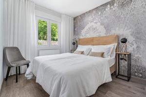 a bedroom with a large bed and a chair at VILLA BEYBE with Jacuzzi, large private pool 50m2, BBQ,free WIFI, 3 bedrooms in Gata +42 photos