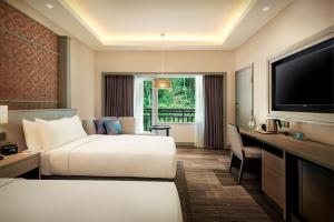 Rúm í herbergi á DoubleTree by Hilton Damai Laut