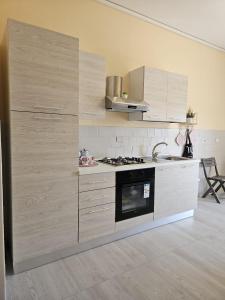 Il comprend une cuisine équipée d'une cuisinière et d'un comptoir. dans l'établissement Royal House Reggia, à Caserte