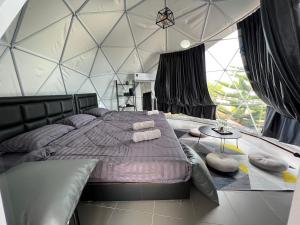 a bedroom with a large bed in a dome tent at See Scape Camping Khaokho in Ban Nong Bong