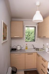 a kitchen with a sink and a window at Anadora 2: Hospitable stone house with yard in Alexandroupoli