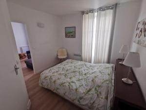 a small bedroom with a bed and a window at Wei&Pei Apartment - St Germain En Laye Center -2min RER in Saint-Germain-en-Laye