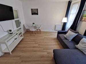 a living room with a couch and a table at Wei&Pei Apartment - St Germain En Laye Center -2min RER in Saint-Germain-en-Laye