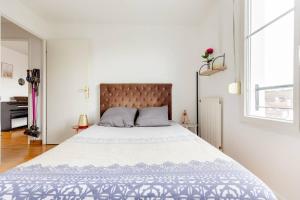 a bedroom with a large bed and a window at Artist Retreat in Noisy-le-Grand