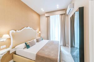 a hotel room with a bed and a window at Gentile Suite & Spa Vomero in Naples