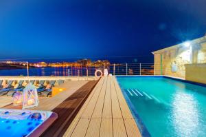 a pool on the deck of a cruise ship at night at Valletta Waterfront Villa with Pool and Jacuzzi in Valletta