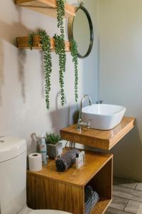 a bathroom with a sink and a mirror at Agapé Boutique Guesthouse Bothaville in Bothaville